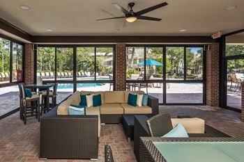 a living room with couches and chairs and a pool